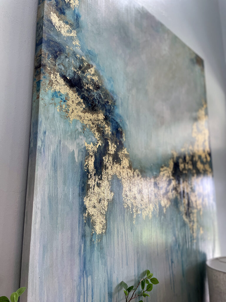 close up of coastal wall art in blues, turquoise, navy and glittery gold
