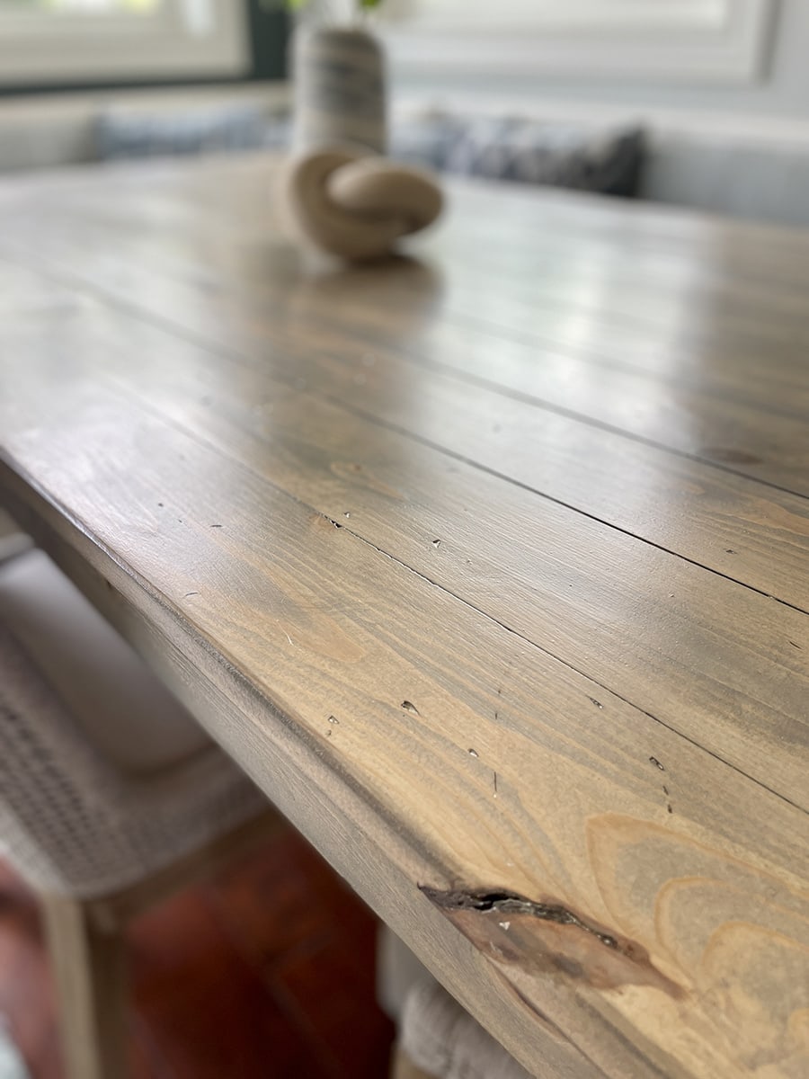 closeup of beachy light stained wood tabletop 