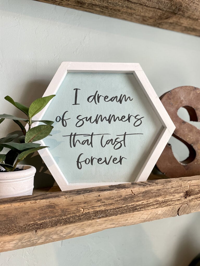 Beachy home decor including sign that says I dream of summers that last forever