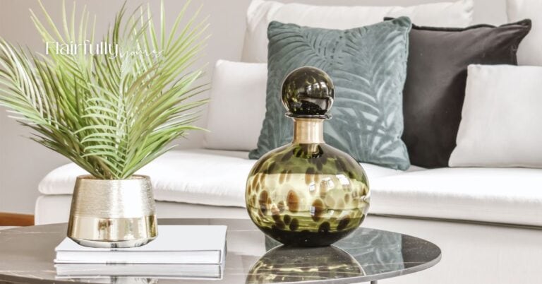 "A chic living room setup featuring a black and gold statement vase, a gold planter with a green palm, and layered pillows on a white couch. Perfect for small room transformations.