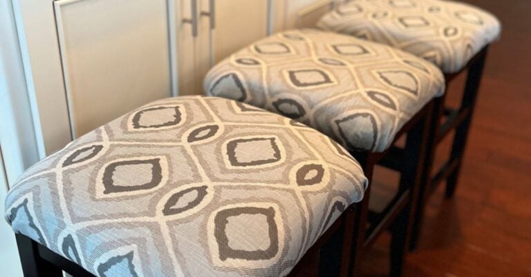 Three counter stools refreshed with soft blue and gray geometric fabric, showcasing a quick DIY seating solution for entertaining or everyday use.