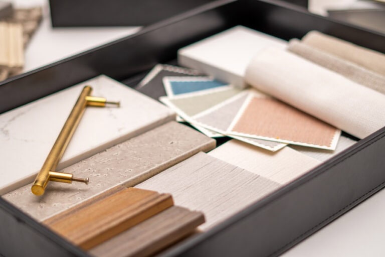 Curated tray of interior finish samples and fabric swatches for coastal decor for home planning.