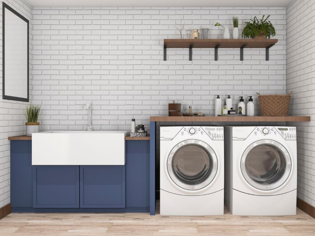 Navy painted cabinets in a high-use laundry room with gold hardware and light counters.