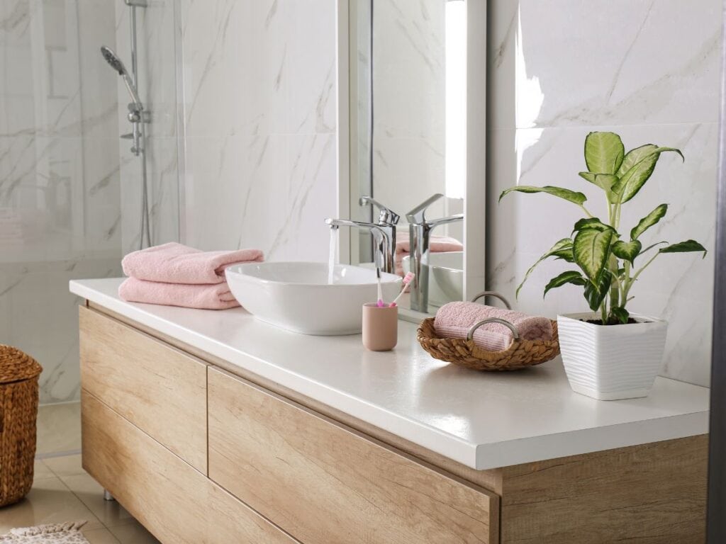 Light wood vanity with modern lines and a soft matte stained cabinetry finish.