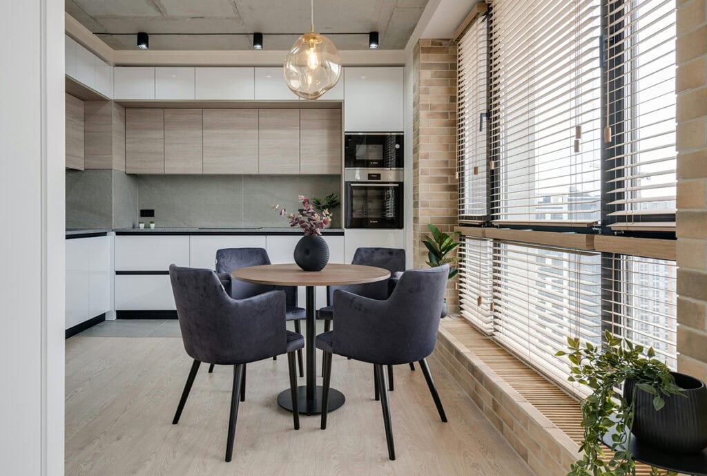 Modern mix of stained wood and painted white cabinets in a minimal kitchen.