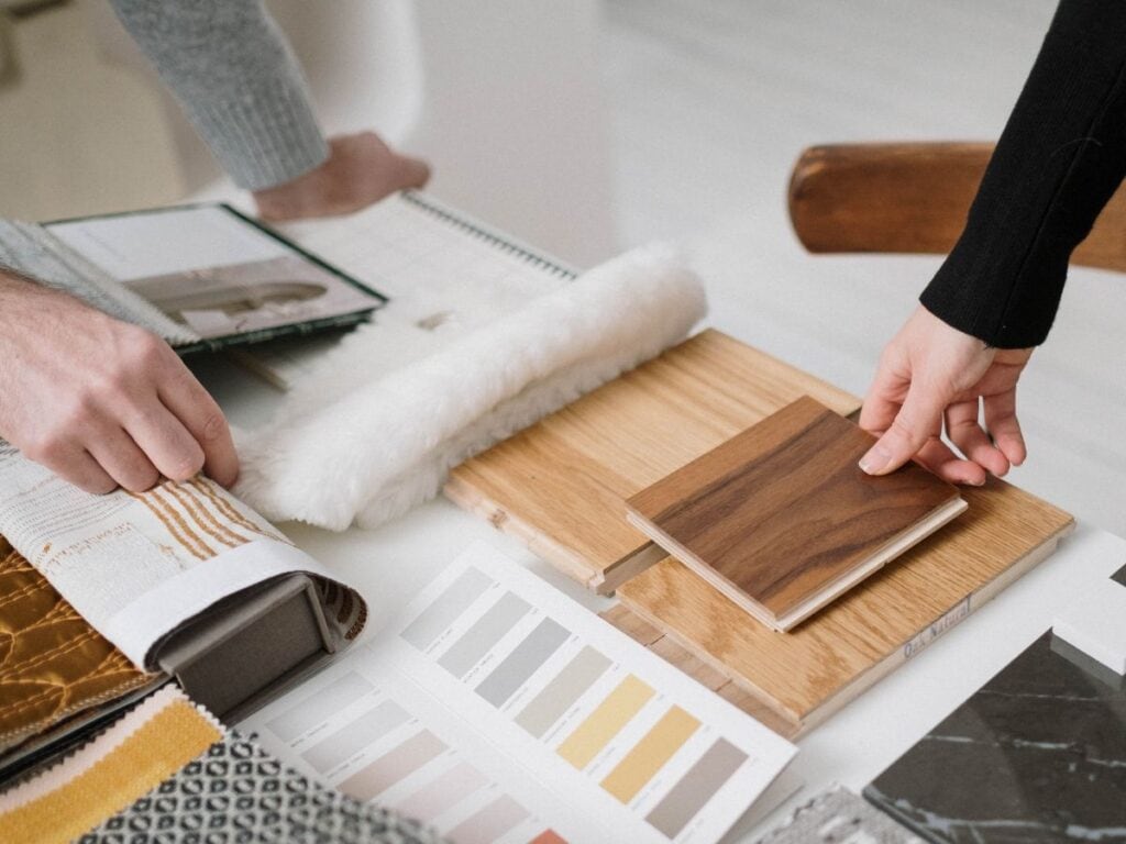 Comparing wood samples and cabinet finish colors side-by-side with fabrics and flooring.
