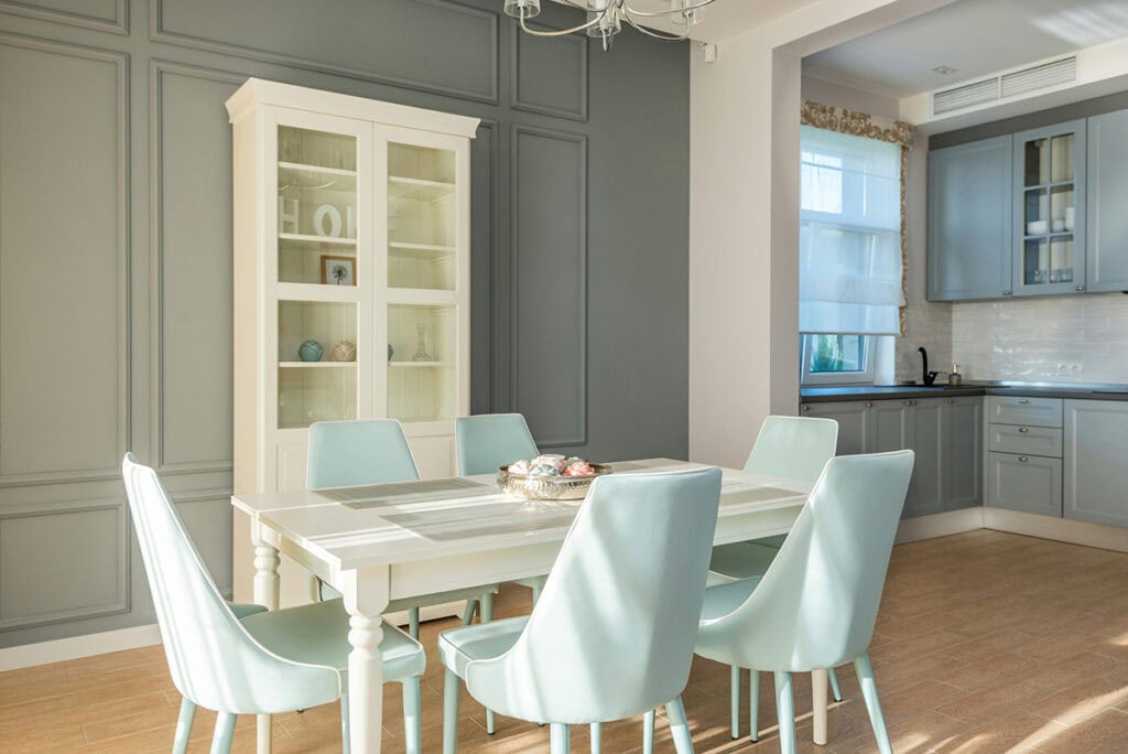 Slate blue painted cabinetry extends into a dining nook with built-ins.