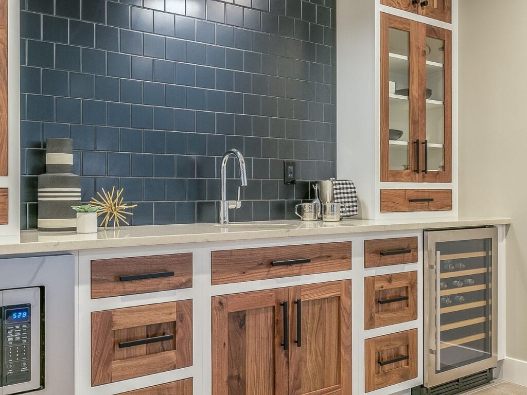 Kitchen cabinets with painted frames and warm stained wood doors for a mixed cabinetry finish.