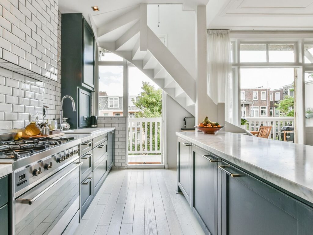 White kitchen with gray island and brushed nickel accents