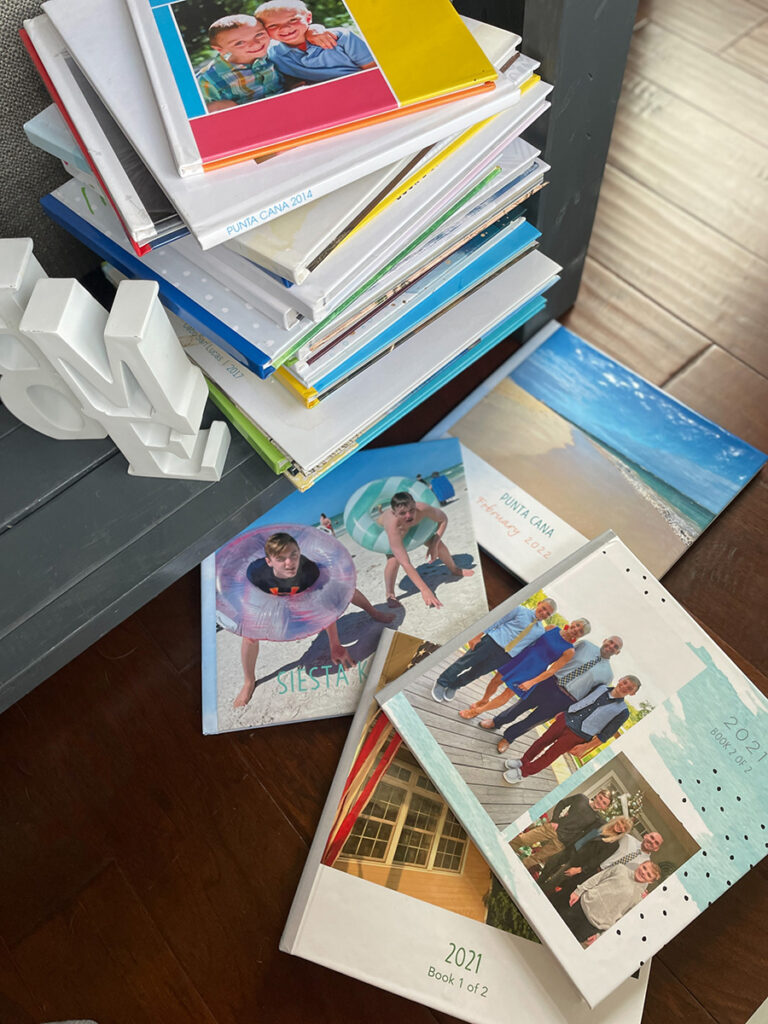 tack of colorful family photo books, ideal for personalizing your coffee table book decor.