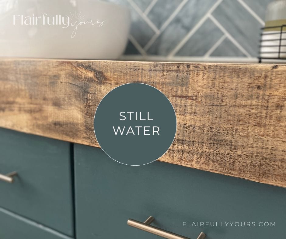 Sherwin Williams Still Water on vanity cabinets with wood countertop in a real laundry room makeover.