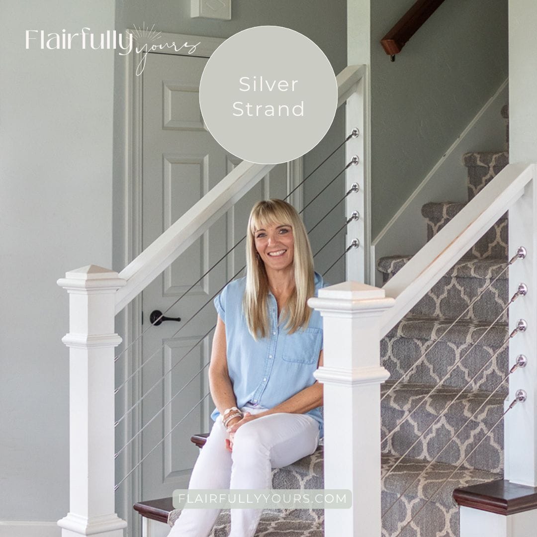 Wendy Schneider of Flairfully Yours sitting on stairs painted in SW Silver Strand, showcasing coastal home style and color inspiration.