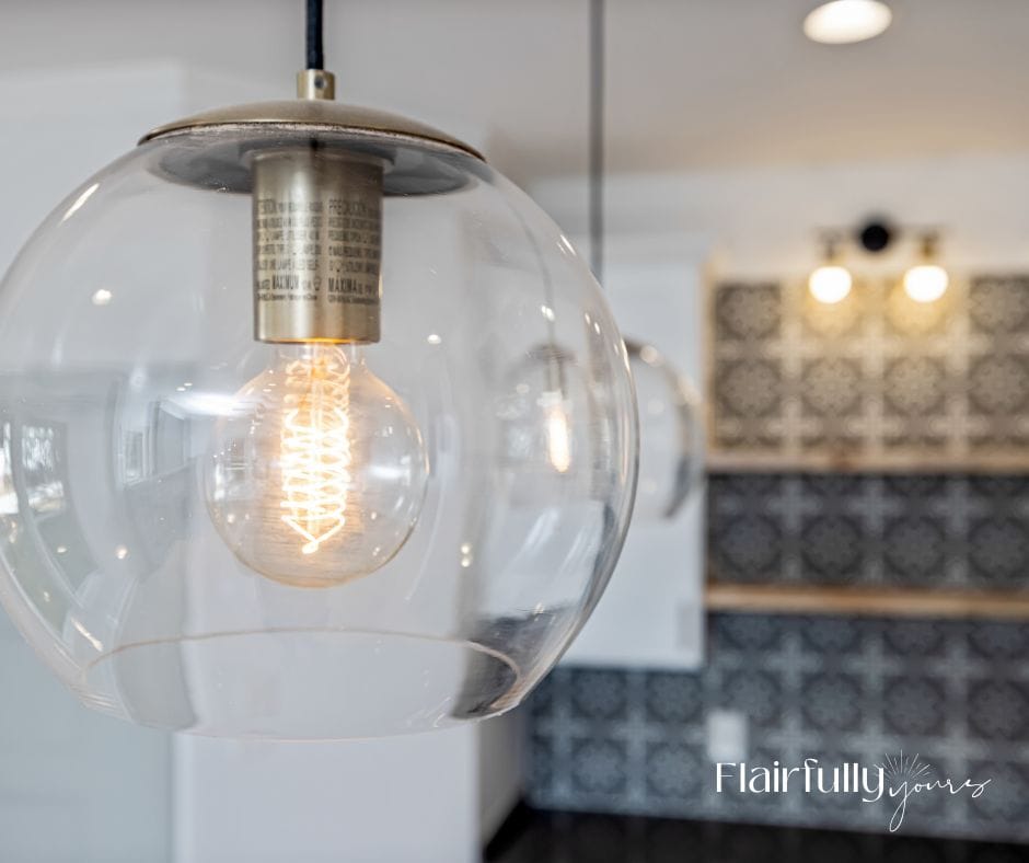 Clear glass coastal lighting pendant with Edison bulb, brightening a modern coastal kitchen.