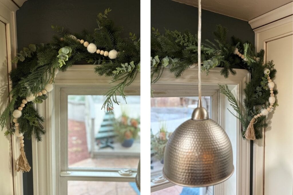 Coastal Christmas garland over kitchen window with soft greenery and wooden beads
