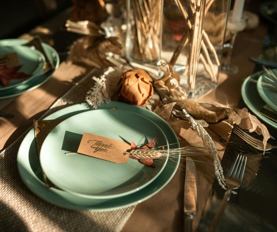 Thanksgiving table napkin tied with twine and a small gratitude tag.