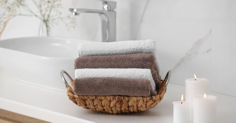New Year Home Reset featuring folded bath towels and candles, a simple way to refresh your home with small updates and post-holiday home decluttering ideas