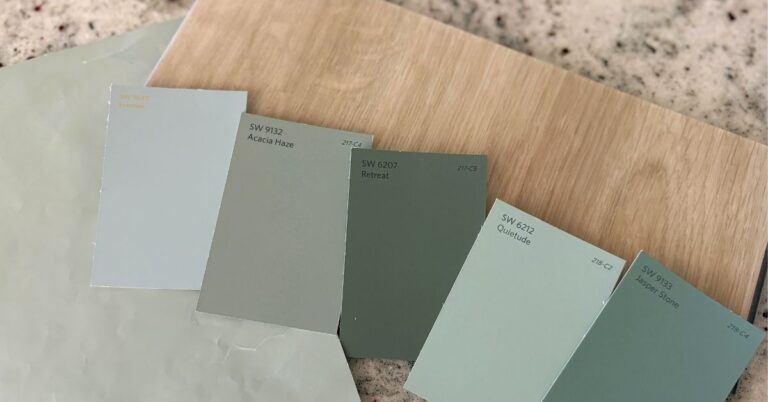Choosing paint colors for your home using layered green paint samples and natural wood tones