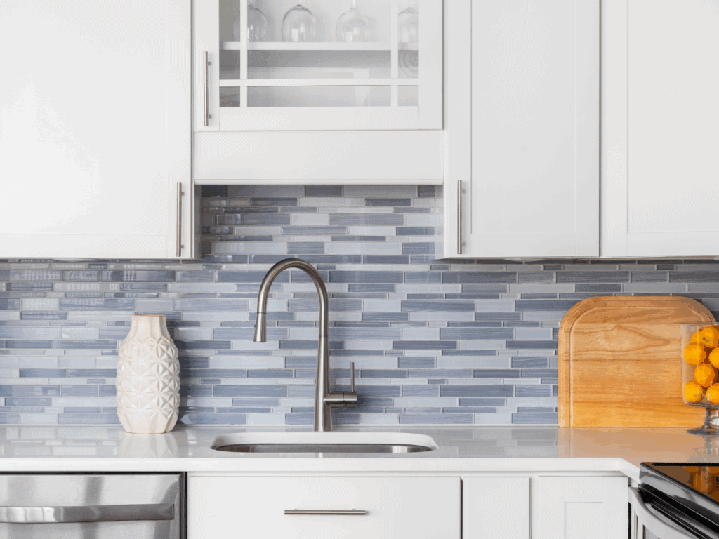 Choosing paint colors by using a backsplash as a single accent color to add contrast without overwhelming the kitchen