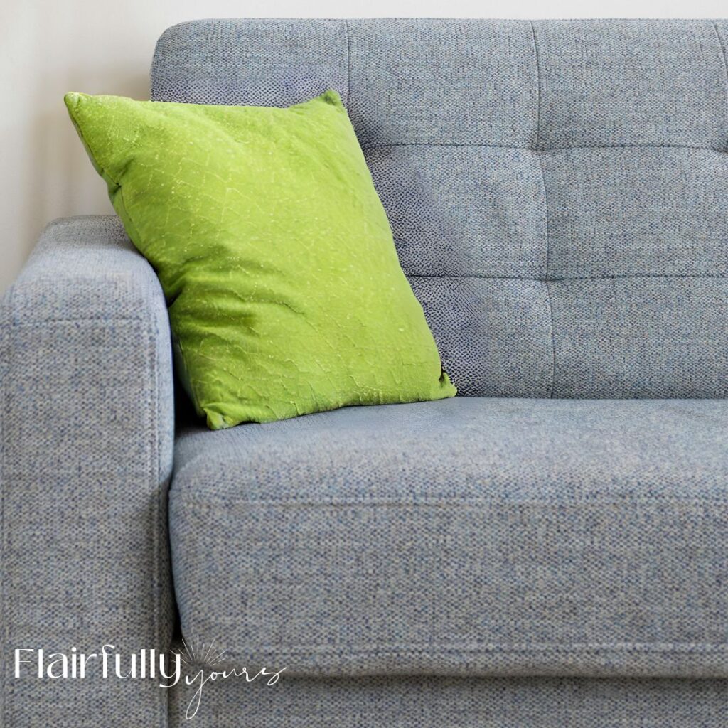 Living room pop of color with chartreuse pillow on a light blue sofa for a balanced coastal look