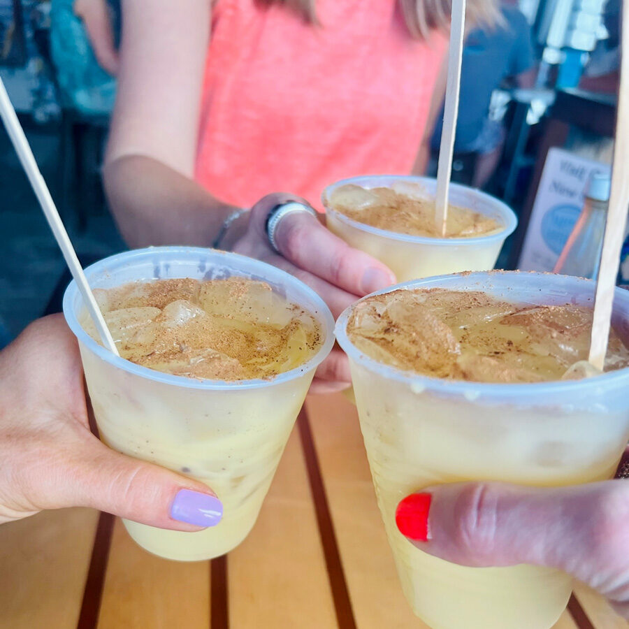 Cheers to island time! A close-up of three Painkiller drinks, the signature cocktail of St. John, with a dash of nutmeg.