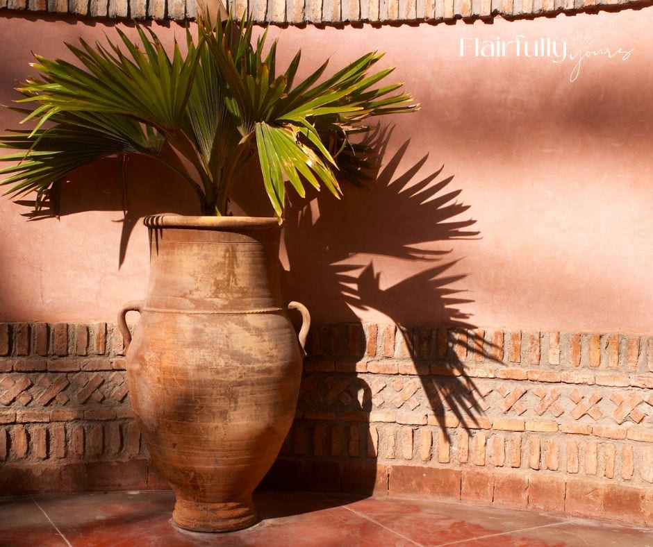 Tall terra cotta vase with greenery, freshening up a dark corner and bringing a spring vibe.
