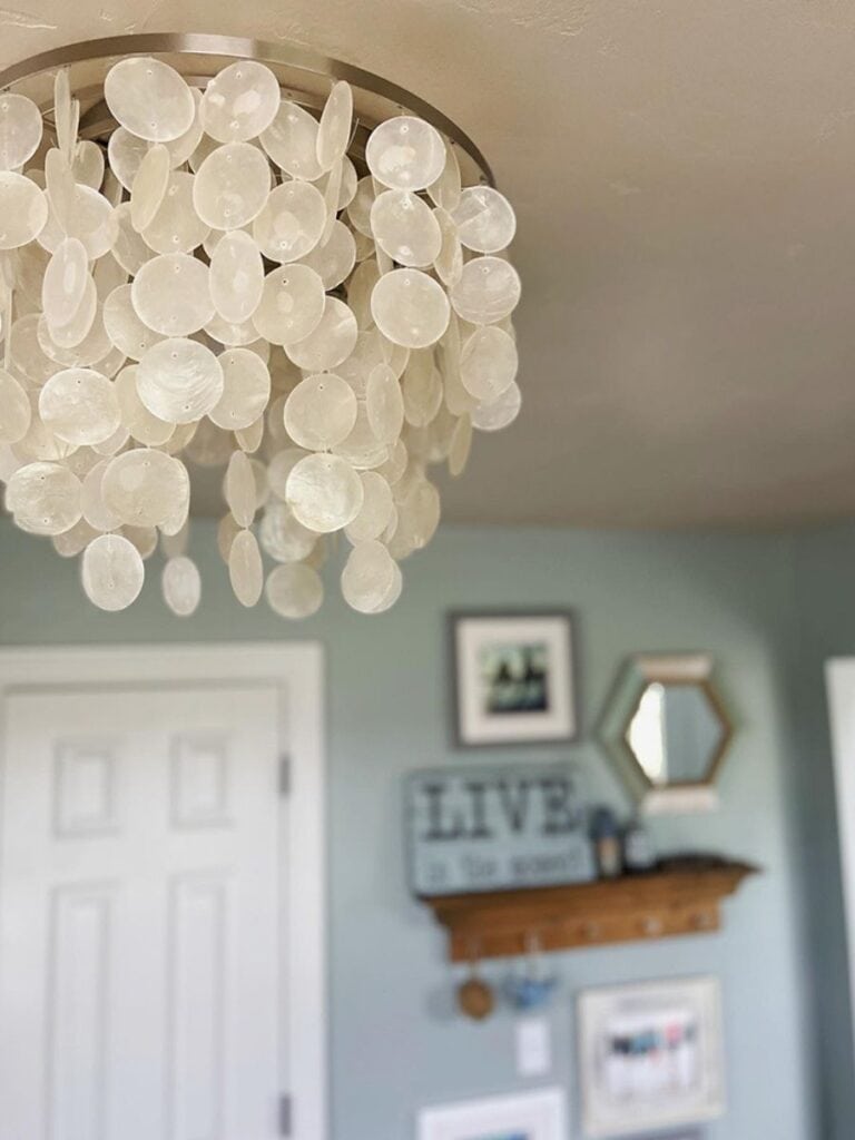 Close-up of a capiz light fixture with hanging discs, offering a serene and luminous lighting effect.