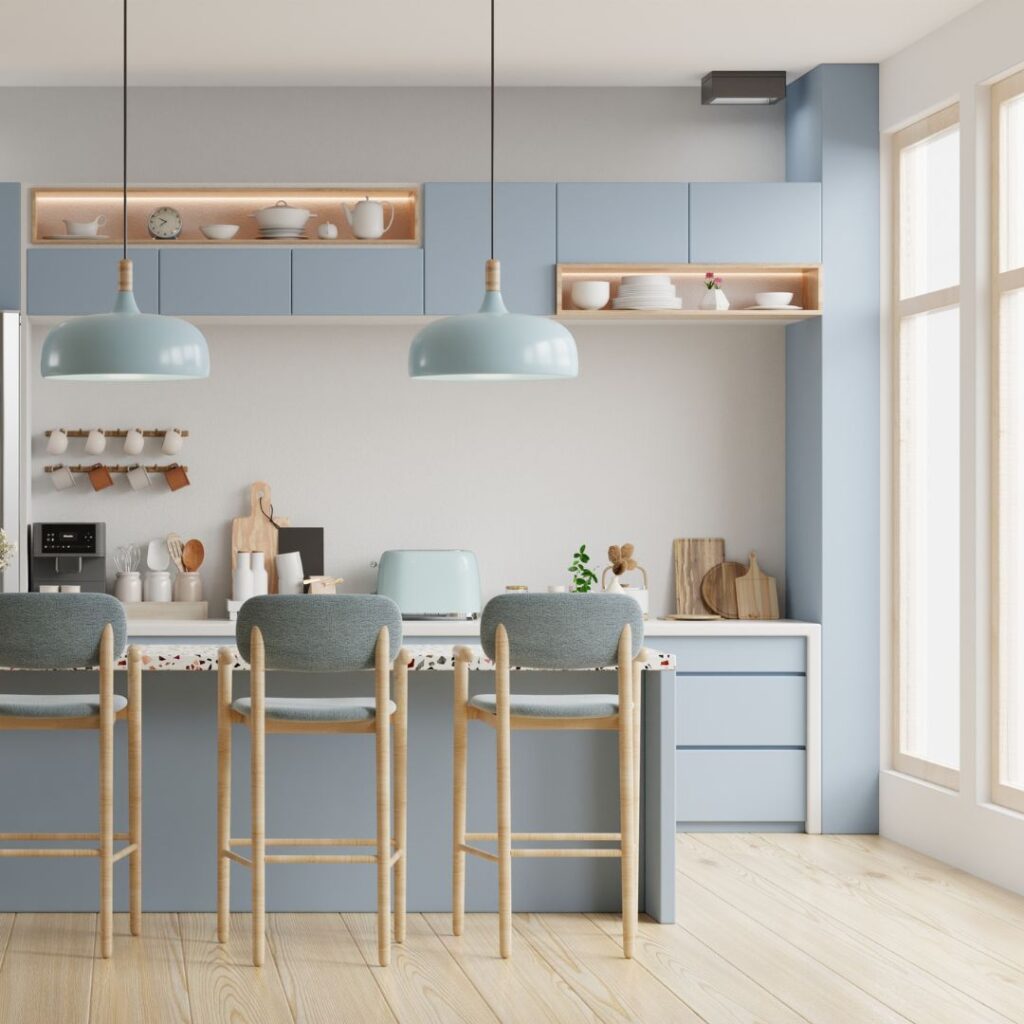 A modern coastal kitchen with blue cabinetry, neutral walls, and natural wood accents that create a calm and cohesive design.