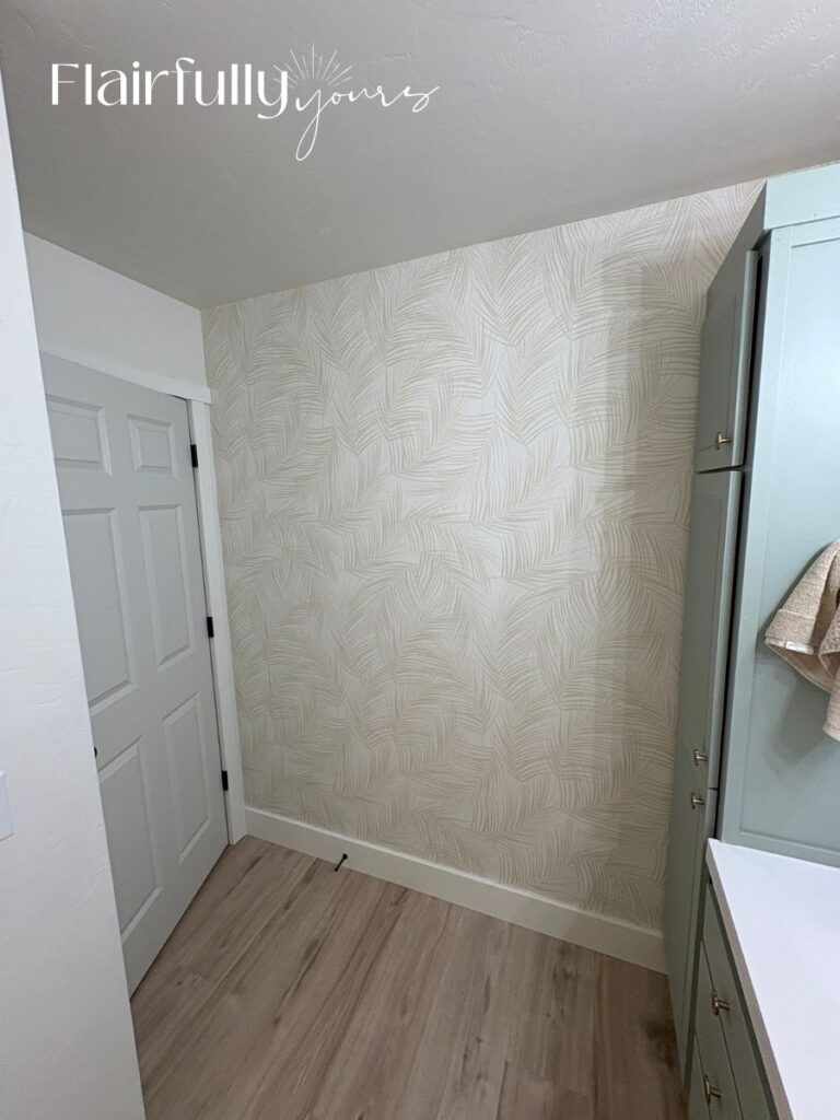 Traditional glue palm wallpaper being installed, highlighting the linen texture on the bathroom wall.