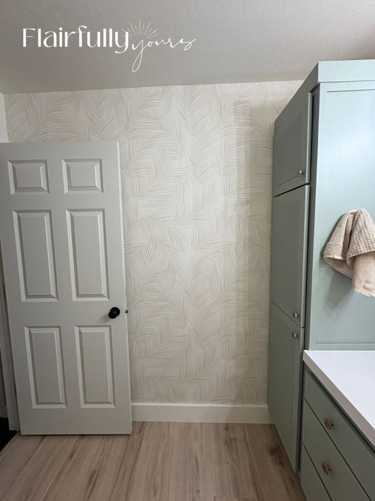 Palm print traditional wallpaper with a linen pattern and off-white background in a bathroom.