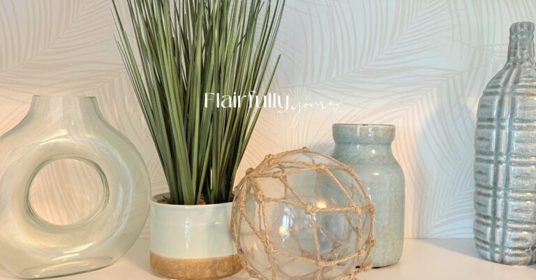 Coastal styling with palm print wallpaper and beach-inspired decor