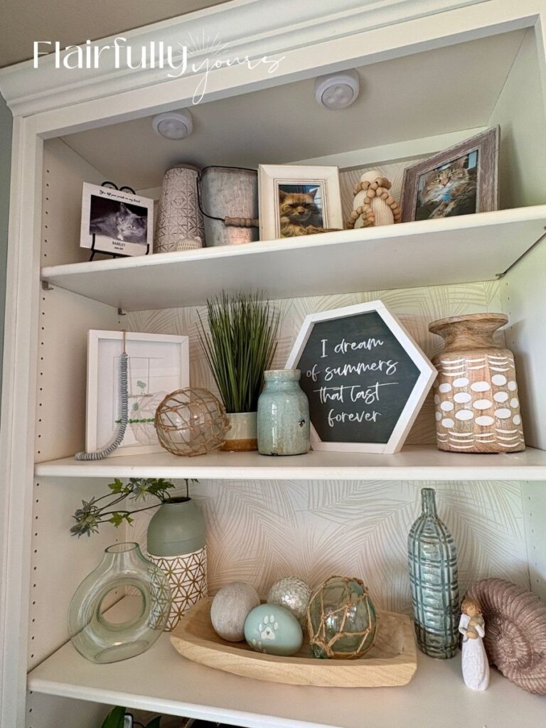 Peel-and-stick palm wallpaper used on office shelves for a coastal-inspired look.