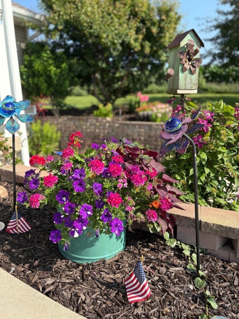 Pink, purple, and red flowers in turquoise planter