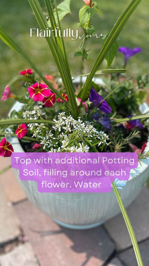 Outdoor planter with vibrant flowers being topped with potting soil, perfect for healthy growth