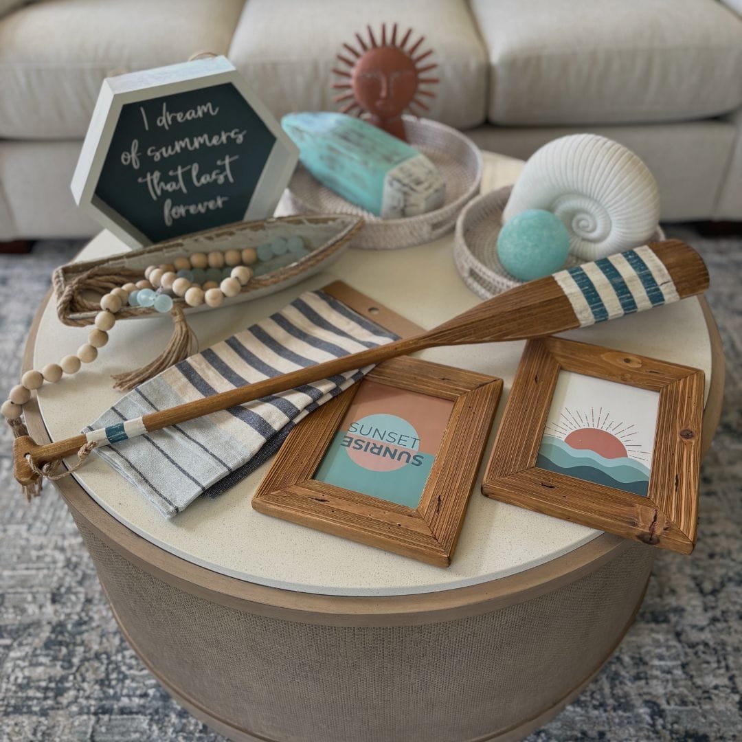 Curated coastal and lake house decor collection featuring navy, aqua, natural wood, white, and terracotta accents that demonstrate a cohesive home color palette.