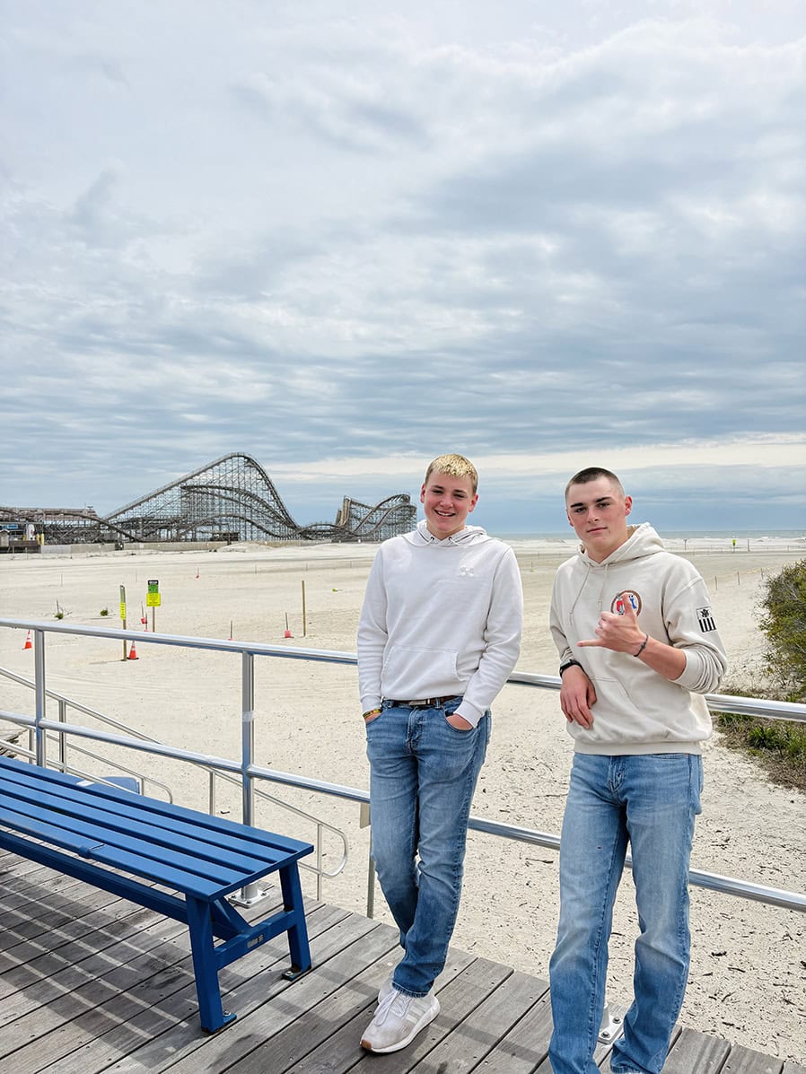 Wendy’s two sons together at the beach, reflecting their family’s love of the water and coastal life.