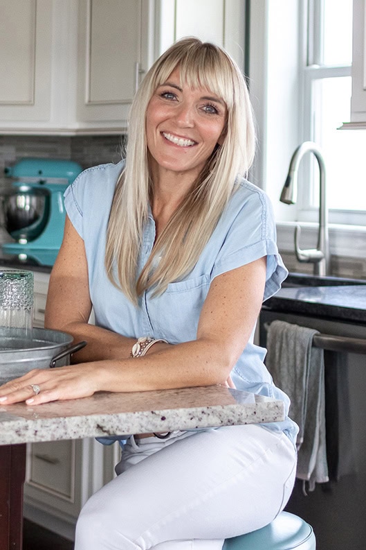Home stylist Wendy in her bright kitchen with coastal-inspired decor and styling details.